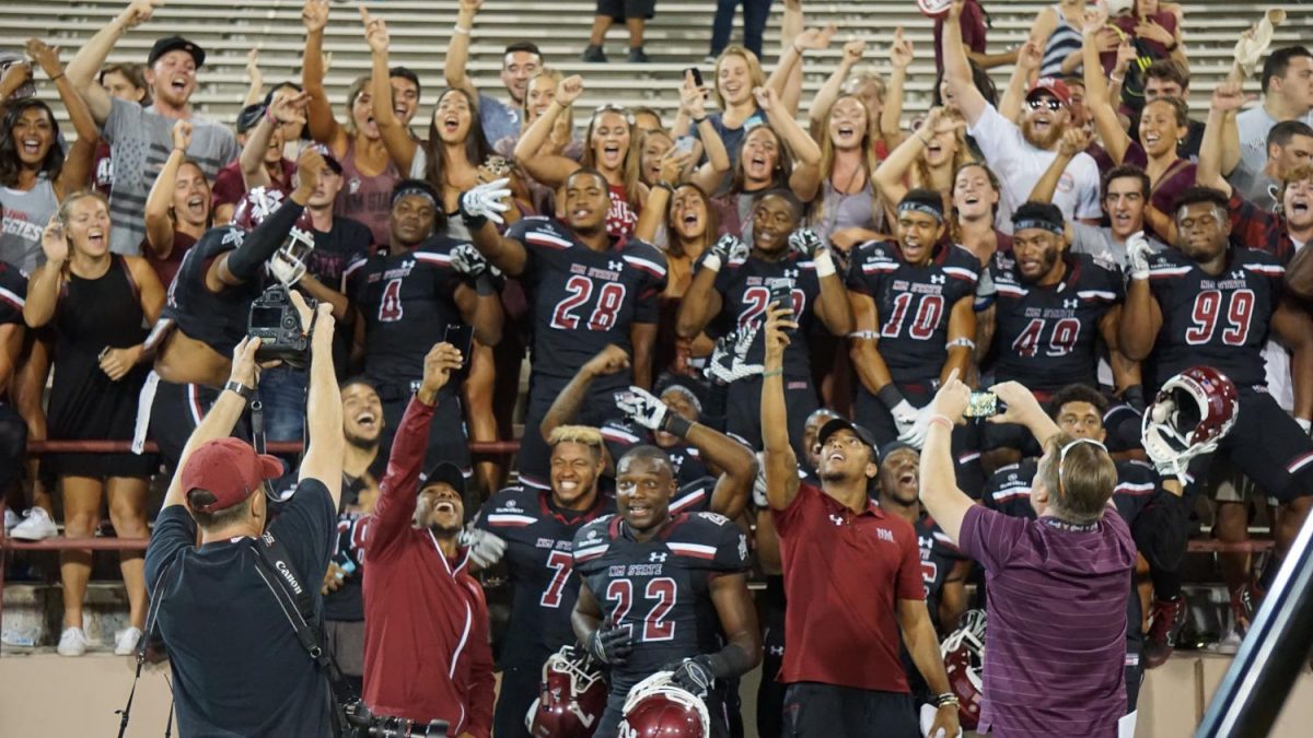Aggie players celebrate a 41-14 thrashing of I-10 rival UTEP Saturday night at Aggie Memorial Stadium.
