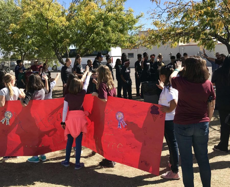 Las Cruces Catholic School students and staff extend their arms to bless the New Mexico State Womens Basketball Team. 