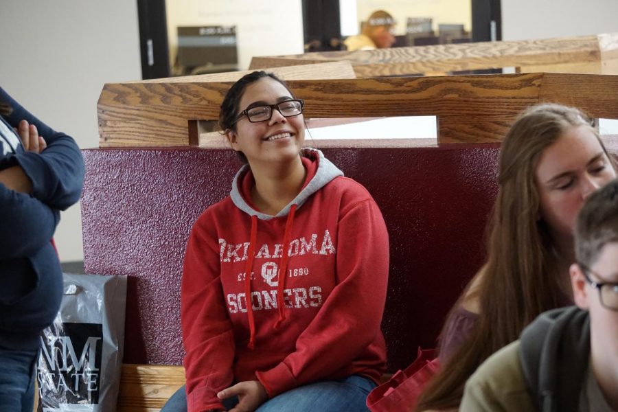 An incoming student listens to faculty members 