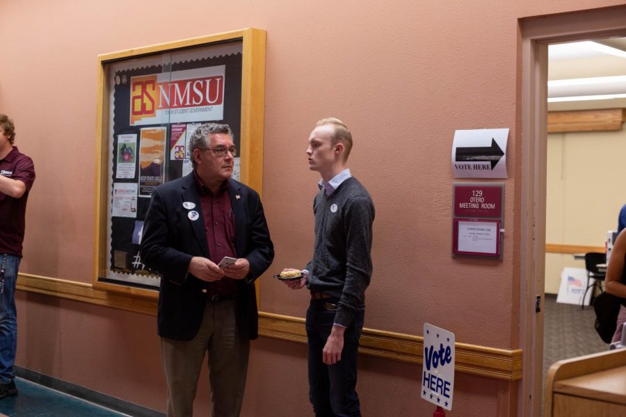 New Mexico State University President John Floros and Associated Students of NMSU President Emerson Morrow    await their turn to cast their ballots for Early Voting in the Corbett Center Student Union building. 