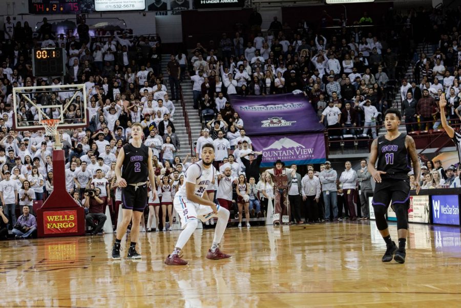 Johnny McCants watches his legendary half-court heave fly toward the basket as the clock expires. Game: Aggies.