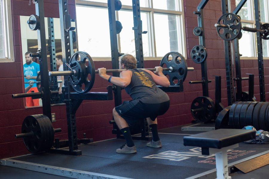 An athlete performs squats in the NMSU Recreational Activities Center on January 28, 2019.