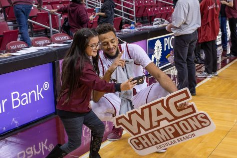 Hometown product Johnny McCants poses with a fan following the Aggies' regular season conference championship.