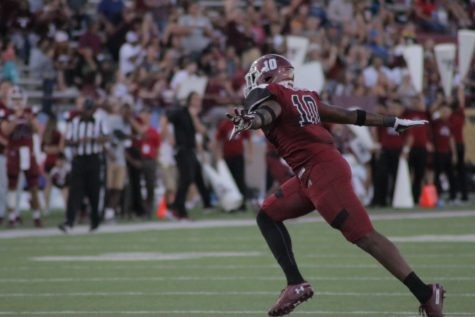 Cedric Wilcots celebrates a sack against Liberty.