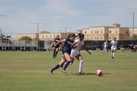 Alexa Barrera jostles with the CBU defender for possession.