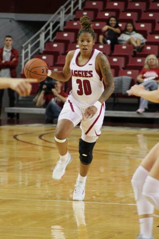 Gia Pack brings the ball up the floor.