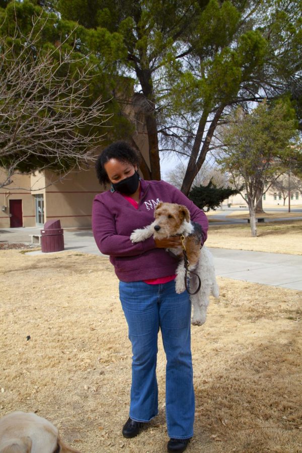 Angela Owens, newly hired director of Glass Family Research Institute for Early Childhood Studies, holds Samson the dog, associated with Guide Dogs for the Blind NMSU Community Puppy Raisers