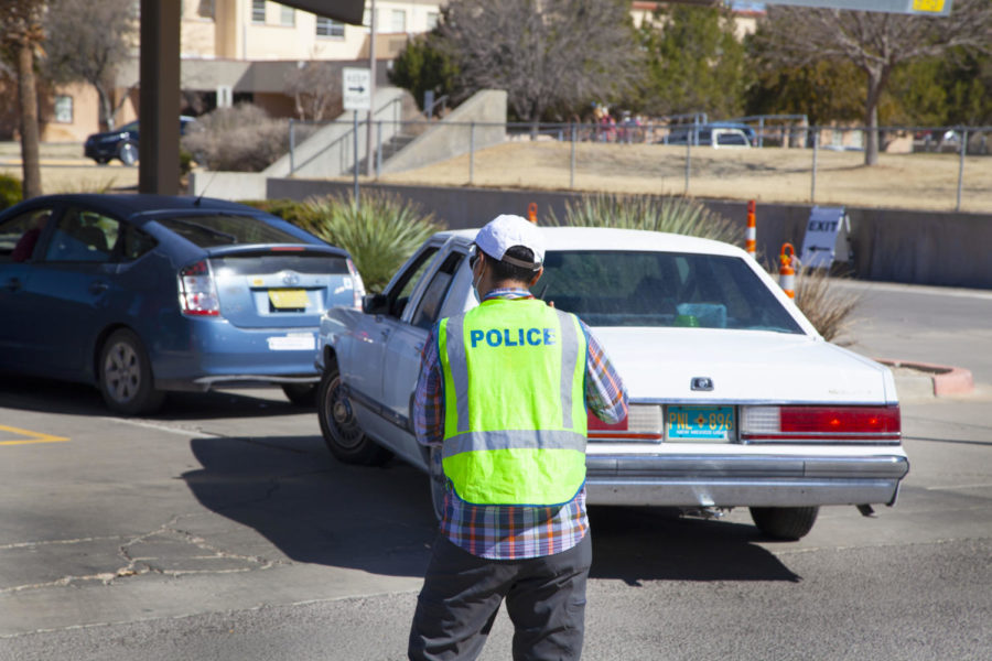 An NMSU Police officer monitors incoming traffic into vaccination lanes for COVID-19. 