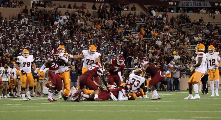 UTEP+Runningback+D.+Hankins+wrapped+up+by+the+Aggie+defense