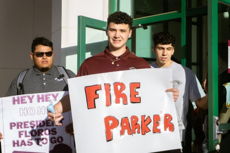 Senator Garrett Moseley for the Associated Students of New Mexico State University holds Fire Parker sign for the removal of NMSU Provost Carol Parker.