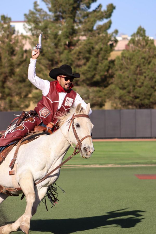 Pistol Pete charging through the baseball field hyping up the crowd for New Mexico States battle against University of New Mexico. Taken on April 6, 2022.
