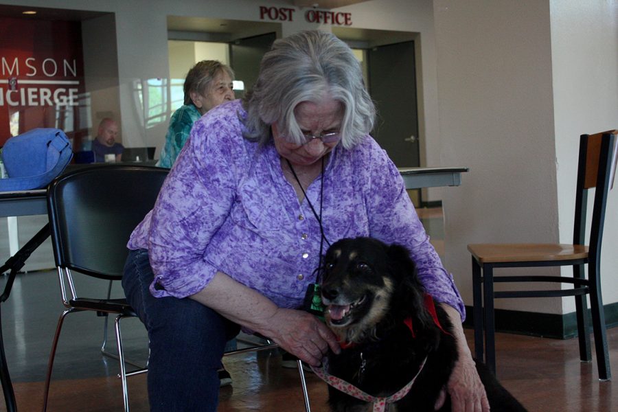 Lisa Archer pets her dog, Tony. Tony is a therapy dog visiting NMSU. Photo taken: April 6, 2022.