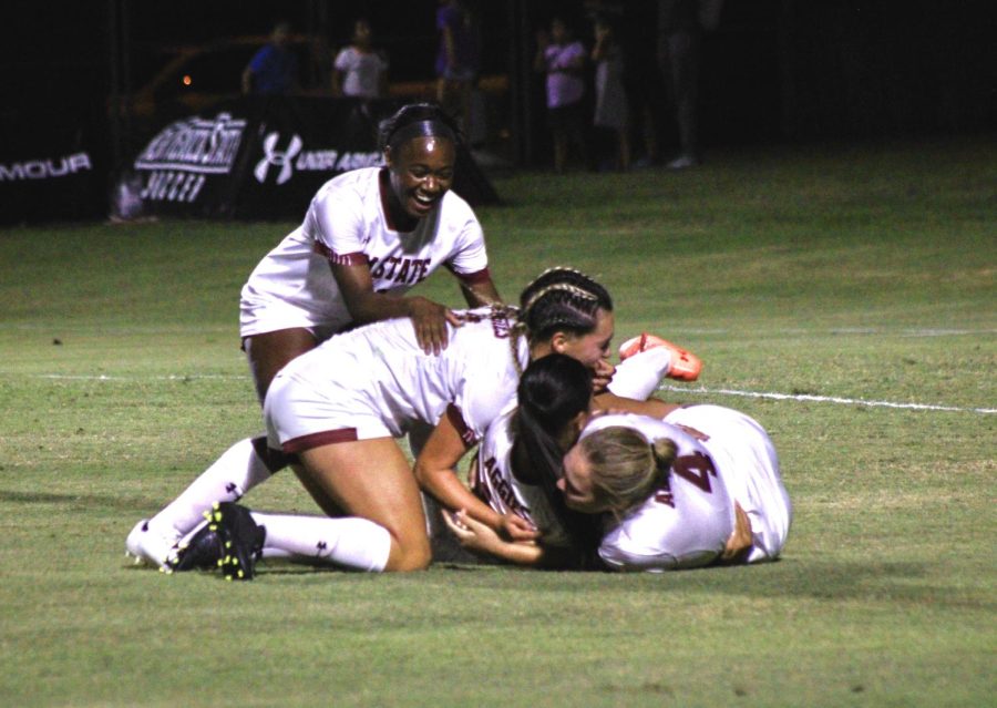 NMSU+Womens+Soccer+celebrate+a+goal+by+tackling+each+other+to+the+ground.+Sep.+9%2C+2022.