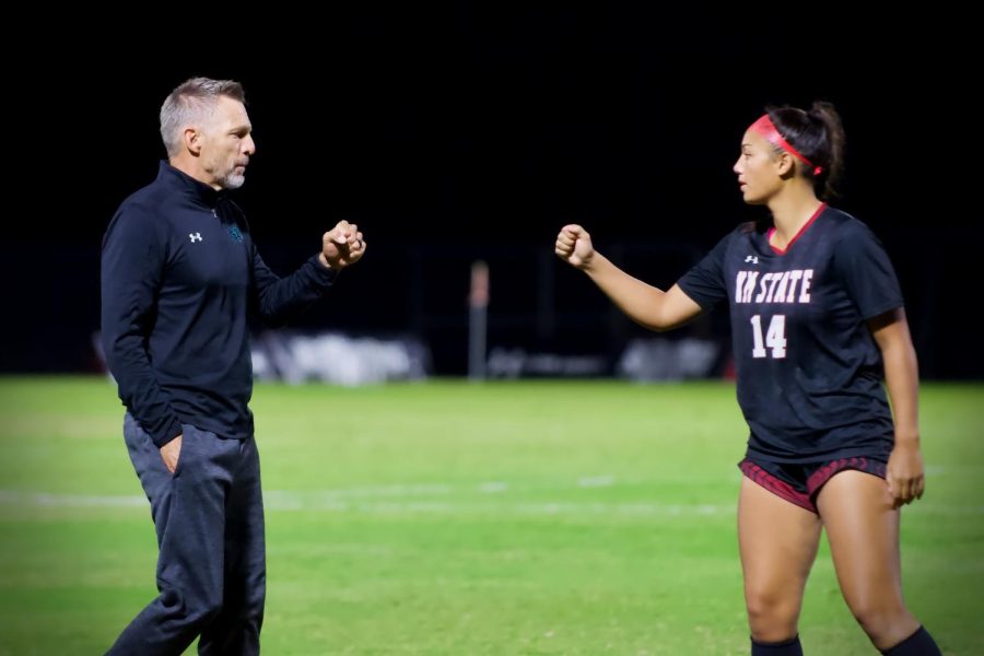 Coach and midfielder Loma Mcneese share a fist bump before the second half. October, 7 2022