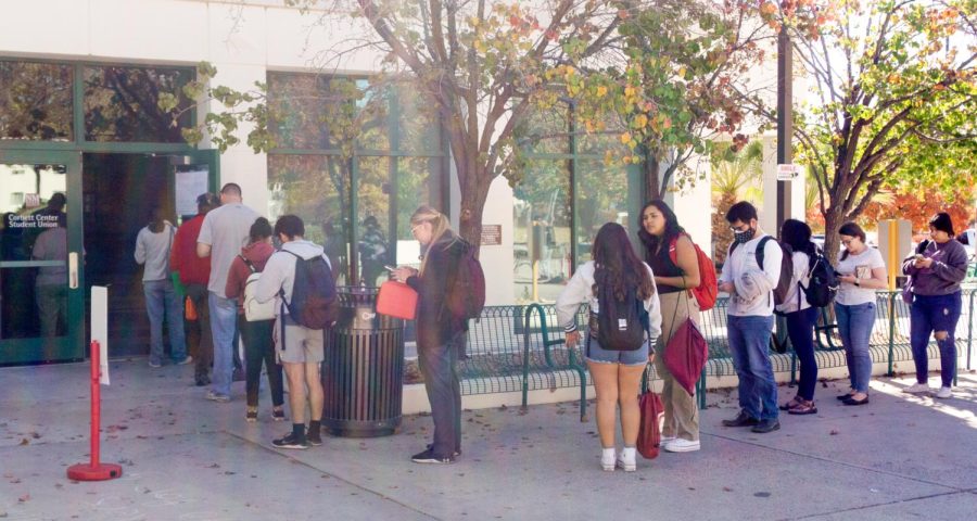 Voters wait in line wrapping around outside the Corbett Center Student Union Polling station to participate in New Mexicos Midterm Election. Nov. 8, 2022.