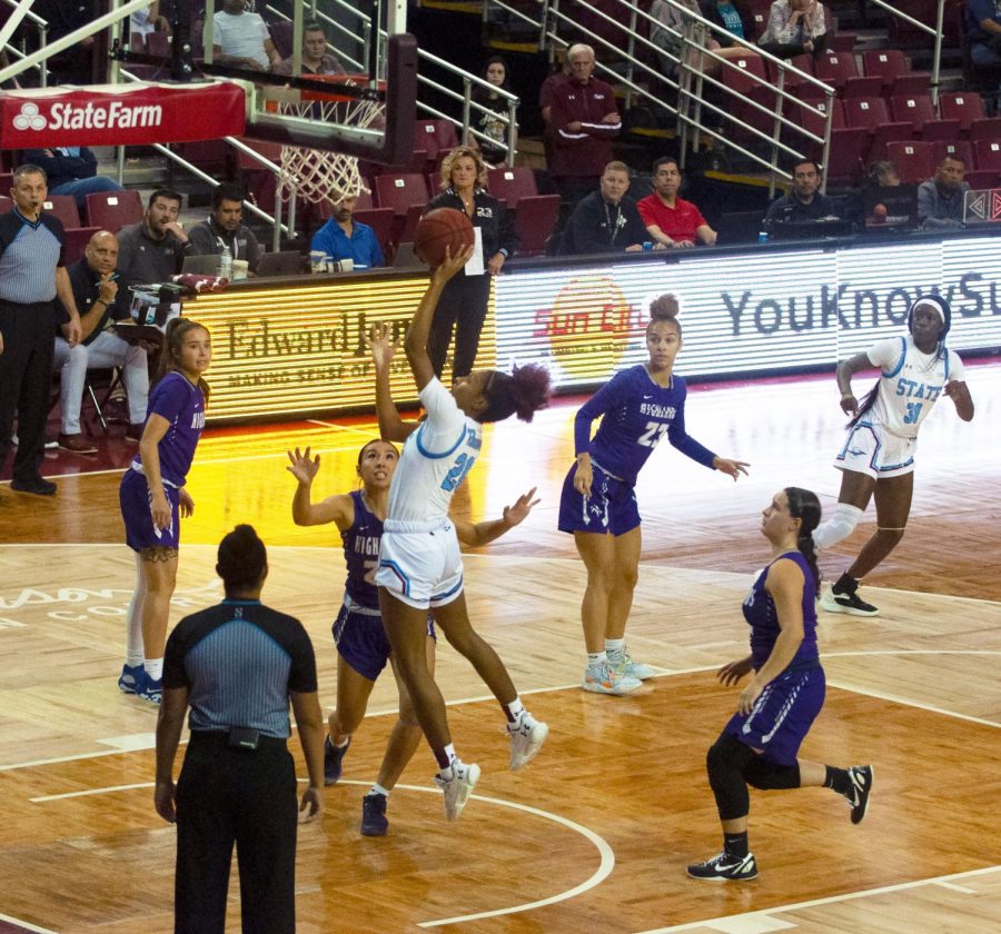NMSU guard Janessa Johnson powers in the lane putting up a shot over a NMHU player on Nov. 9, 2022. 