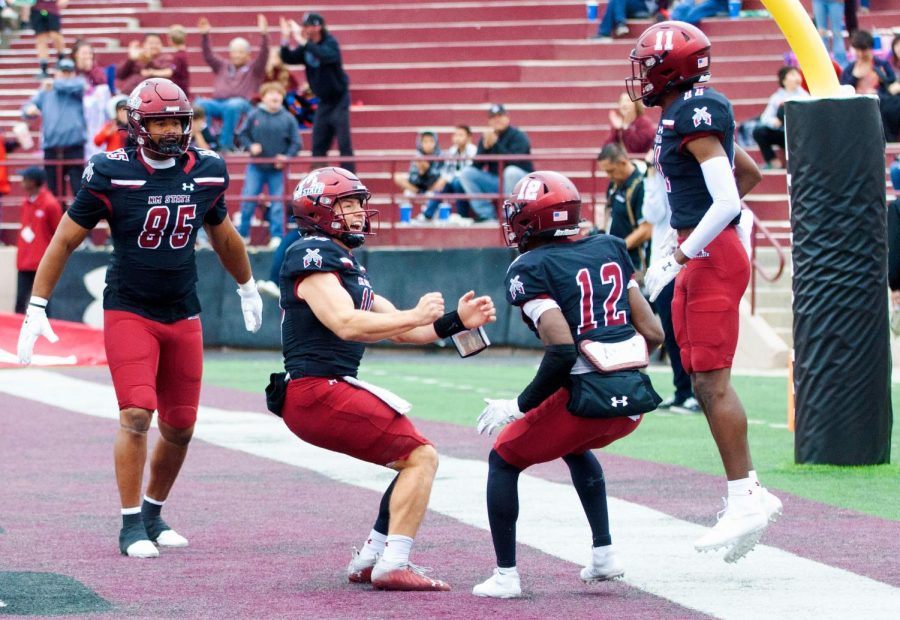 New Mexico State quarterback Diego Pavia celebrates with wide receivers Jonathan Brady and Kordell David after scoring a touchdown against Valparaiso on Dec. 3, 2022 at Aggie Memorial Stadium.