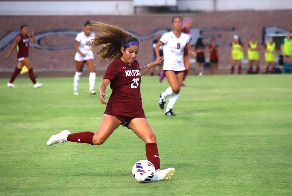 NM States Xitlaly Hernandez drives the ball upfield. 