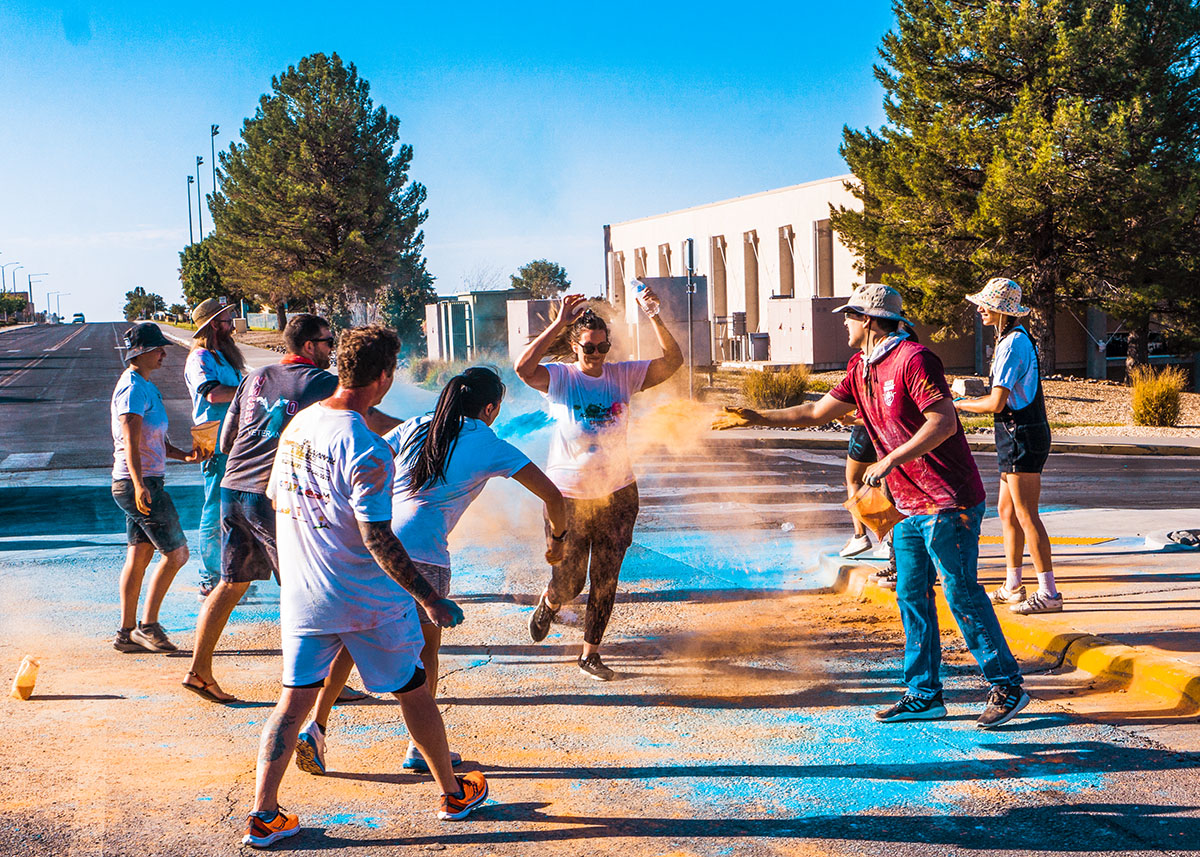 Runners fundraising for Camp Hope covered in colored chalk on Saturday, Sept. 9.   