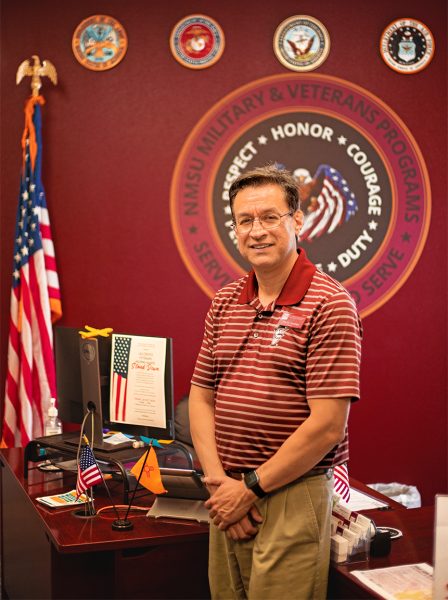 Head of the Military and Veterans Programs, Hector Sanchez, poses in front of the organizations logo. Sept. 13, 2023. 