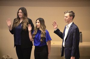 Newly appointed senators, Isabelle Diaz, Regina Rodella, and Jackson Williams raise their hands while taking oath during Thursday’s senate meeting on August 31, 2023.
