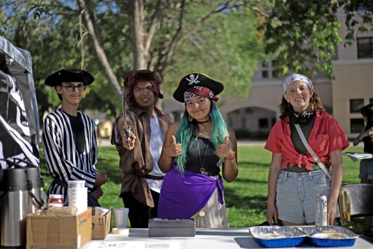 NMSUs Quiz Bowl team participating in their pirate-themed bake sale, hoping to reach potential members and raise club funds. 