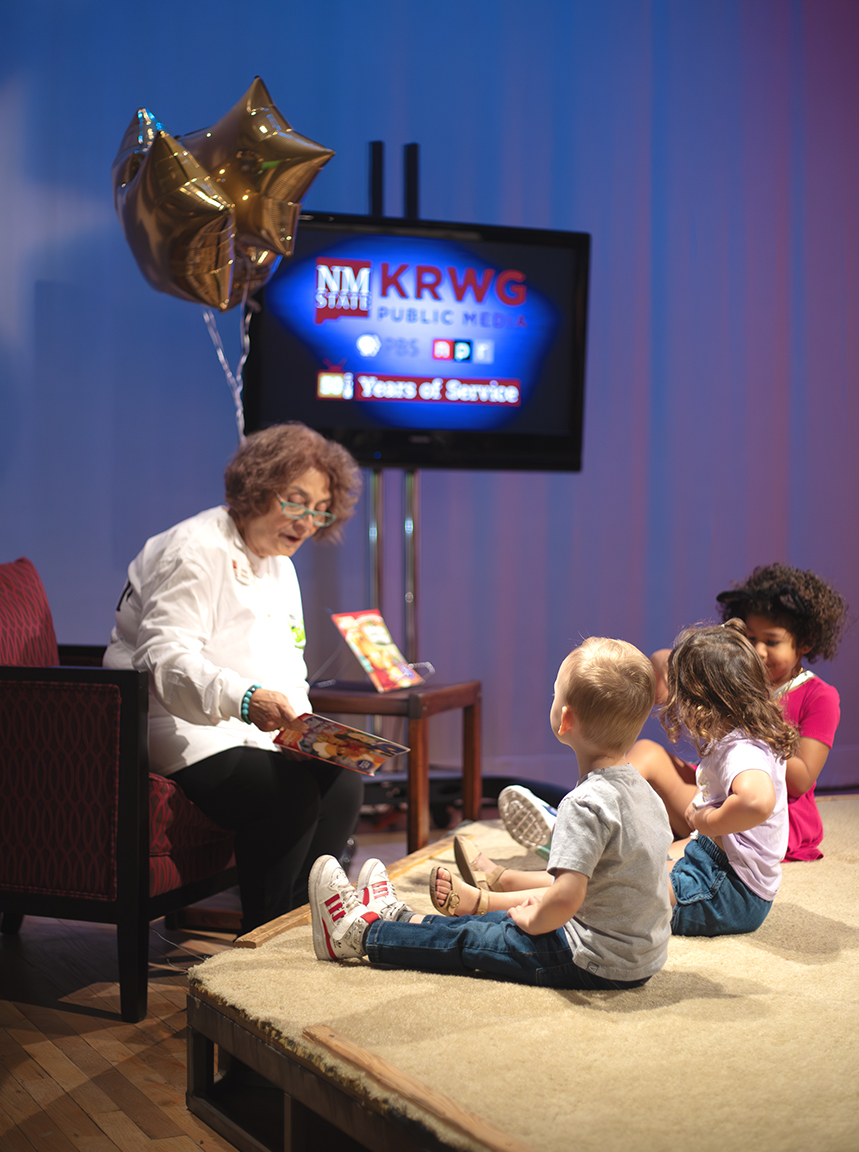 Emily Guerra, host of Fiesta on KRWG, reads Daniel Tiger to a group of children on Sept. 29, 2023.