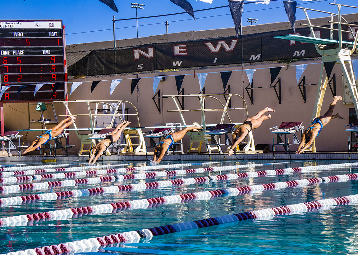 NMSU womens swim and dive team diving for the 100-yard fly event. Sept. 27, 2023