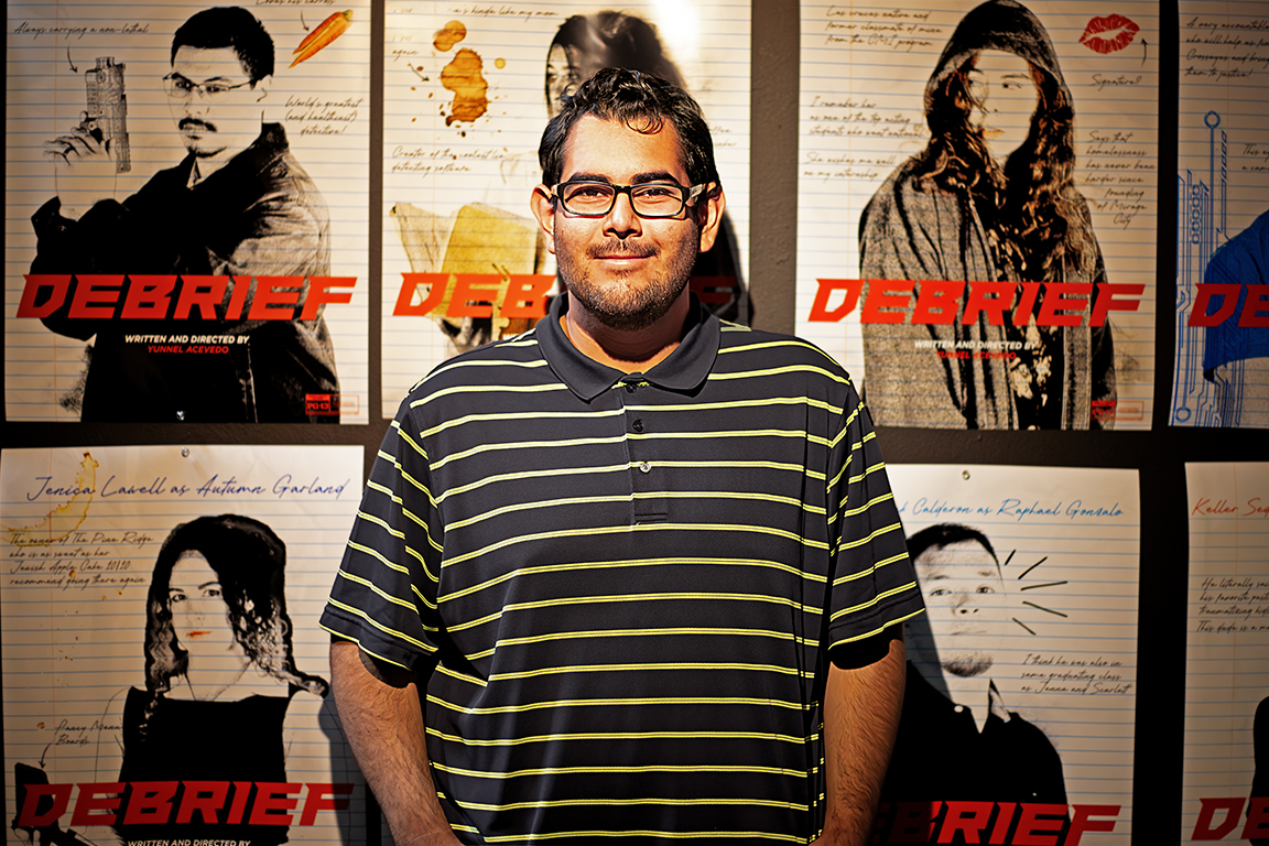 Yunnel Acevedo stands next to his art piece, Debrief, Saturday, Nov. 4, 2023.
