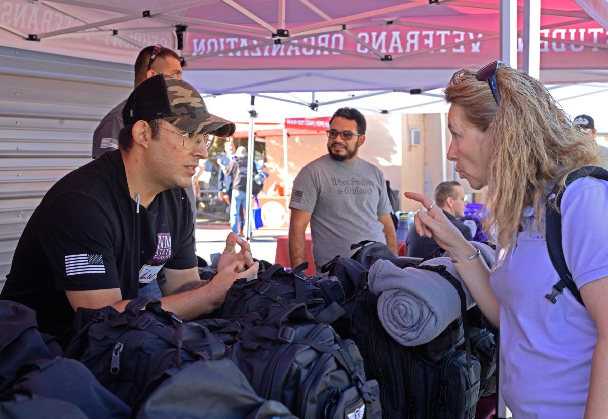 NMSU student Zachary Flores assists at the Military and Veterans Programs booth on Oct. 20, 2023, to distribute backpacks full of toiletries and other necessities.