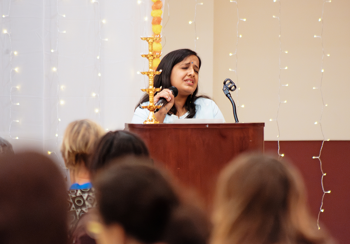 Preeti Maurya sings a Hindu prayer before the Roshni celebration starts, Sunday, Nov. 5, 2023.