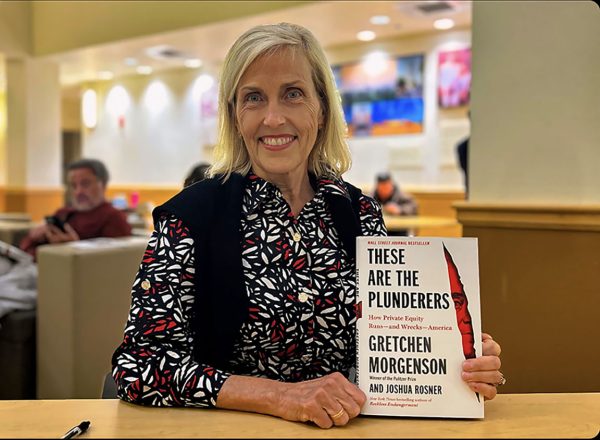 Gretchen Morgenson posing for a picture with her book, These are the Plunderers How Private Equity Runs — and Wrecks — America. Feb. 20, 2024.