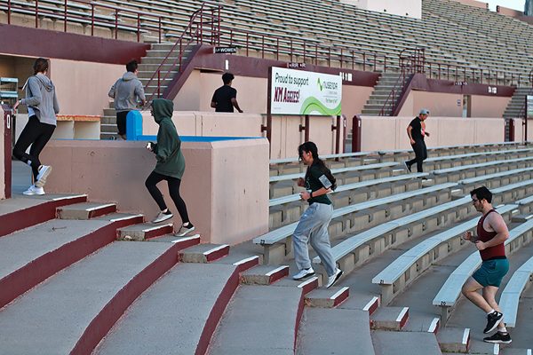 NMSU’s Swim, Bike, Run Club members run up and down stadium steps on March 25, 2024. This exercise is a part of the clubs weekly stairs session.