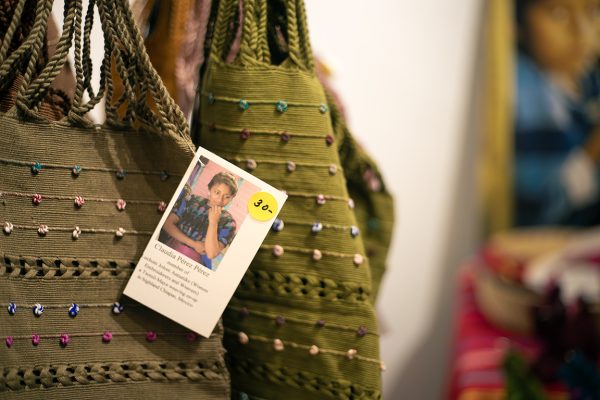 Tags are featured on many of the purchasable items from Weaving for Justice, displaying the makers name, picture and background. March 8, 2024.