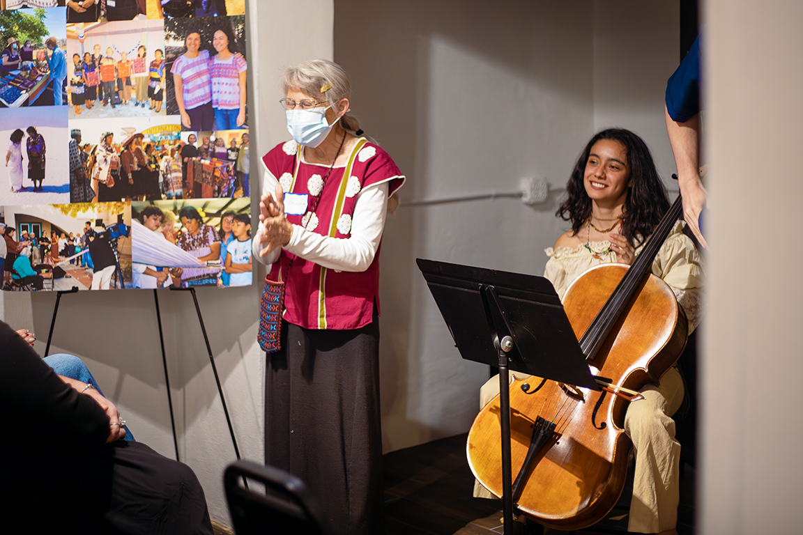 Christine Eber (left), co-founder of Weaving for Justice, introduces the concert section of the International Women’s Day event on March 8, 2024.