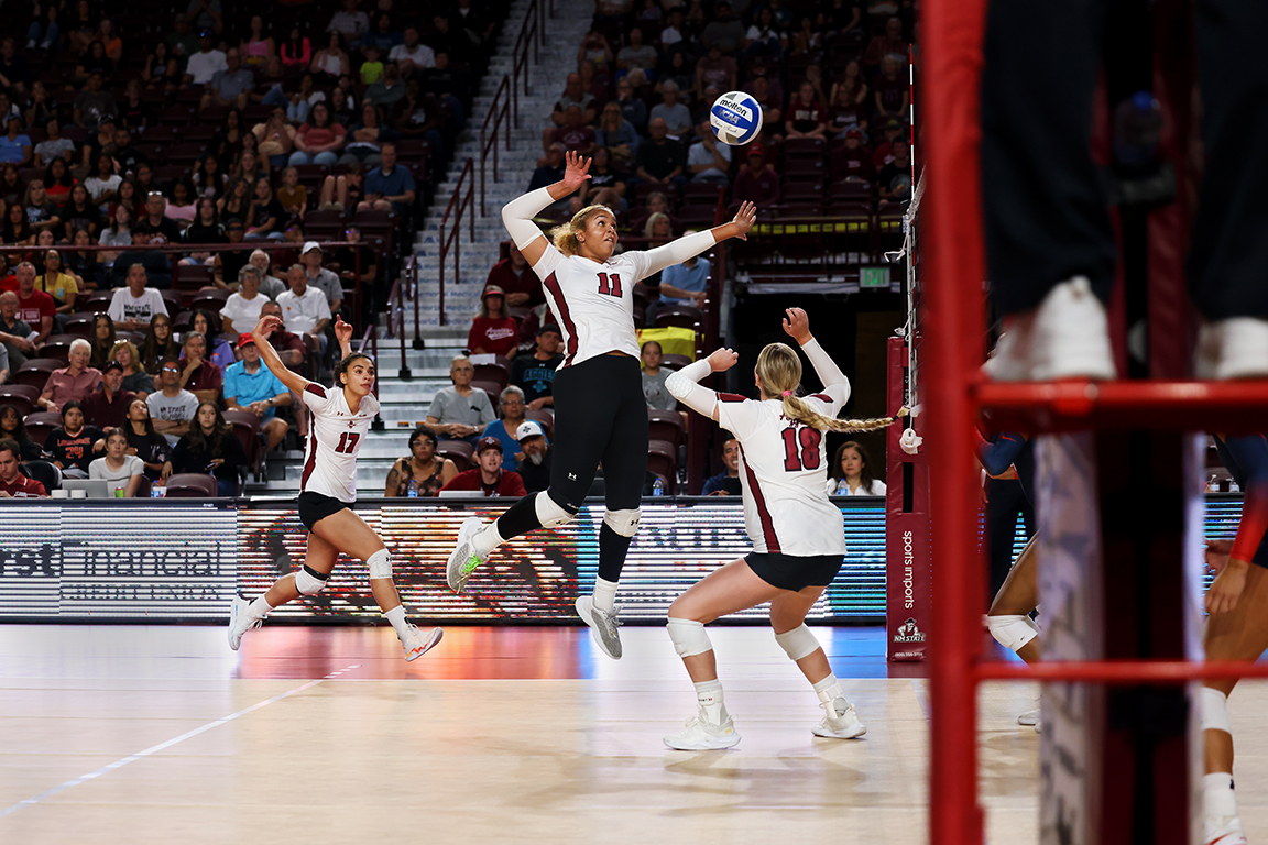 NMSU’s Nellie Reese set the ball for Kacia Brown to spike against UA in the Pan American Center during the Borderland Invitational on Saturday, Sept. 14, 2024.  