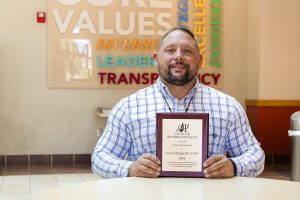 Casey McDougall holds his 2024 Educator of the Year award, awarded to him by the APA's Society of Prescribing Psychologists, on Friday, September 20, 2024. 