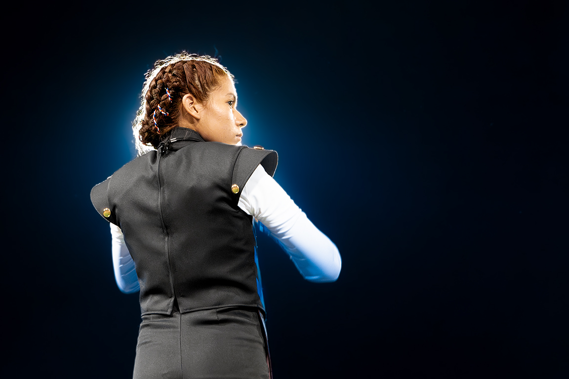 Americas High School Drum Major Idaly Perez prepares to conduct the band. Sept. 21, 2024.