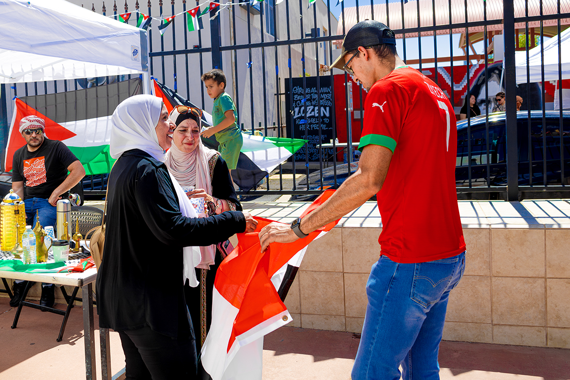 The NMSU International Club took pictures with other vendors holding their countries' flags. Sept. 21, 2024.