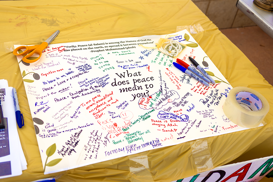 Spectators were asked to write down their definition of “peace” on a poster board. Sept. 21, 2024.