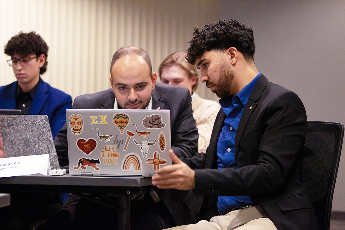 ASNMSU Senators Youssef Aly (left) and Ethan Ortiz-Ulibarri (right) discuss a resolution during a senate meeting on Oct. 17, 2024.  