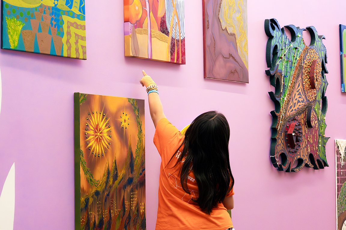 A young girl points to one of the art pieces displayed in Carlos Rosales-Silva’s “Border Destroyer”. Sept. 27, 2024. 