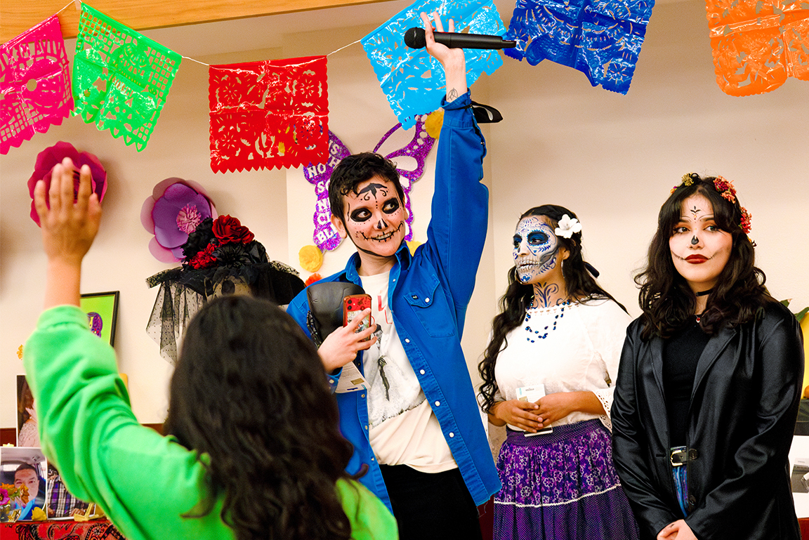 Dr. Rio López asks attendees to raise their hands to vote for their favorite Catrina makeup. Nov. 4, 2024. 