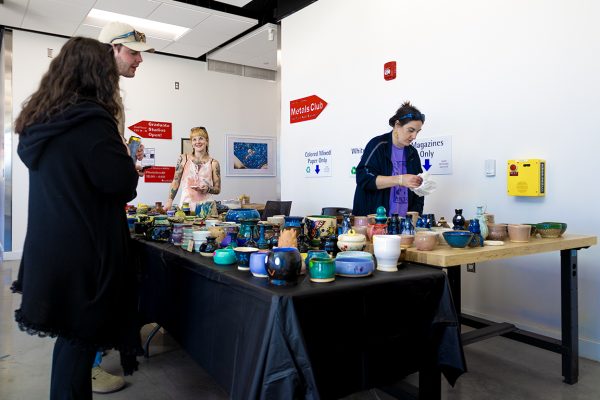 Open Studio attendees talk to artists about their pottery items. Nov. 9, 2024. 