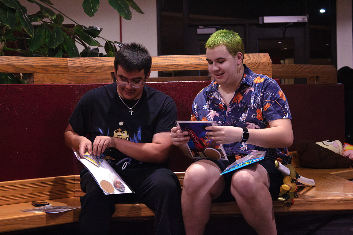 Two students pack up their purchases from local artists who visited NMSU for the Anime convention. Oct. 23, 2024.   