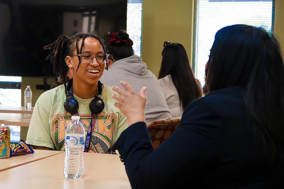 Black Programs office assistant Angel Ennis smiles as she talks with a guest. Feb. 5, 2025. 