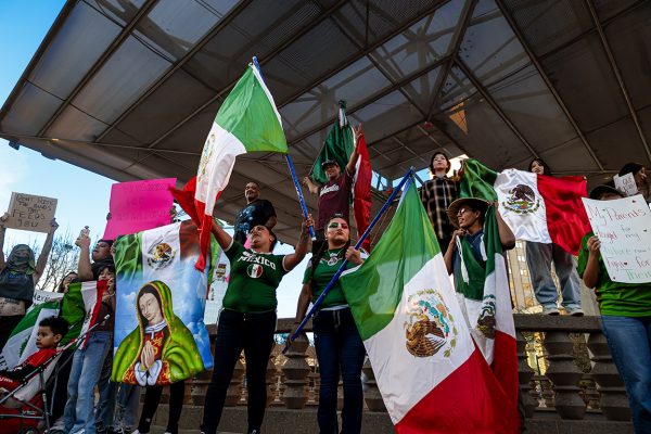 Protesters stand together around the Alligator pond in San Jacinto Plaza, El Paso. Feb. 5, 2025.