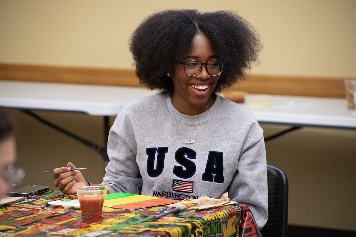 Aaliyah Walker smiles as she paints and talks with program advisors. Jan 30, 2025.