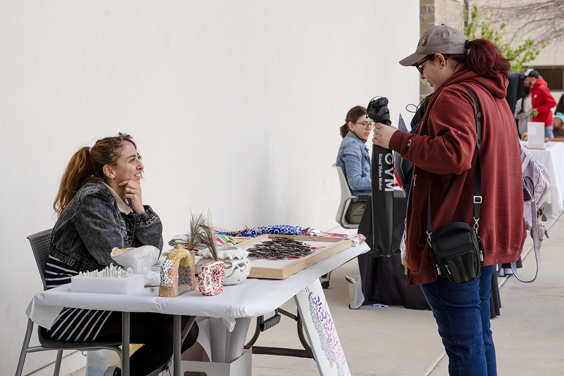 Elham Sabri, an Iranian-born artist getting her MFA in Studio Art, sells her work at the Big Bang Bash, and prepares for her upcoming exhibition. April 3, 2025. 