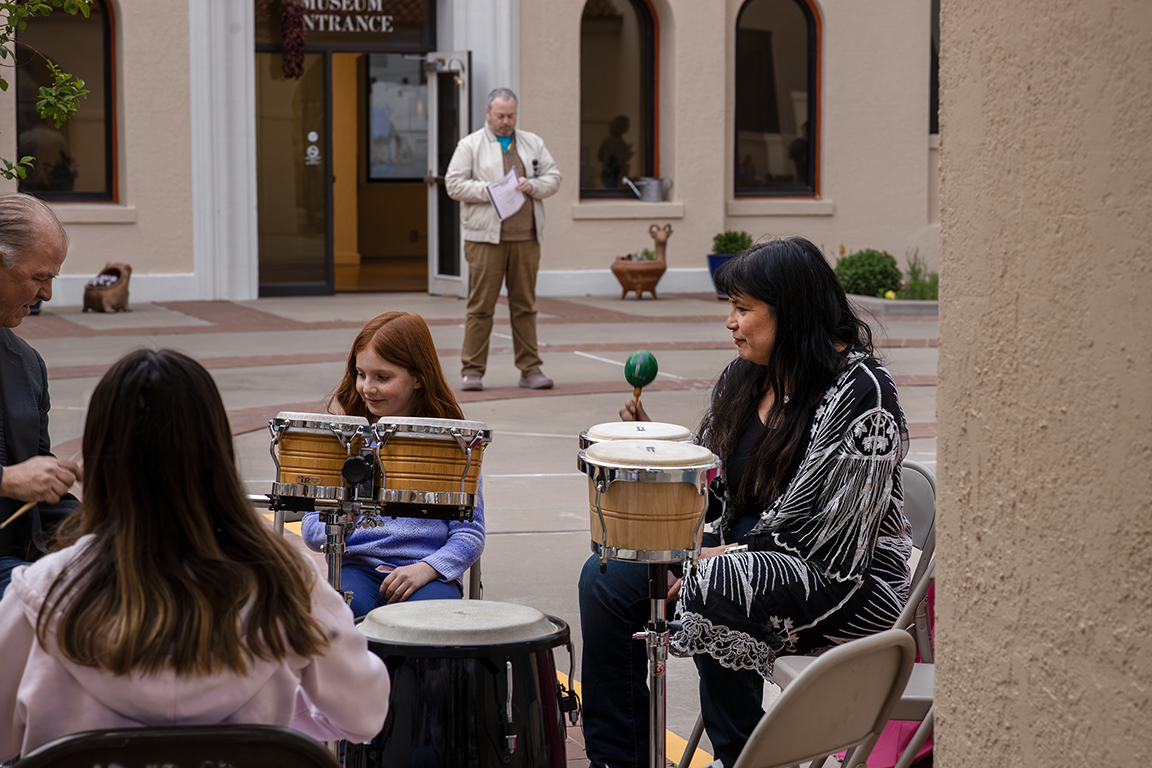 NMSU’s Theater Arts instructor Monica Mojica (right) plays percussion in the University Museum courtyard. April 3, 2025. 